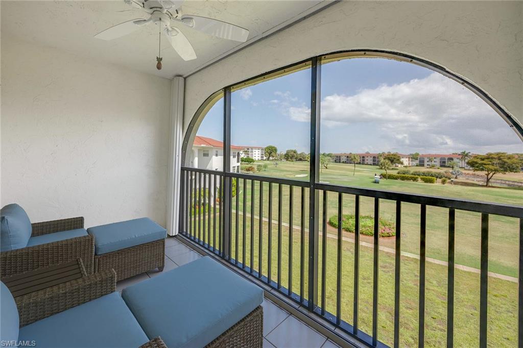 45 High Point Circle South, Unit 303 Naples, FL 34103 - Photo 18 of 22 a living room with furniture and a floor to ceiling window