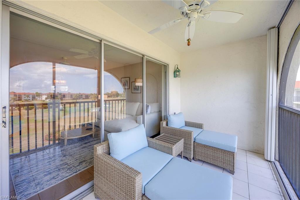 45 High Point Circle South, Unit 303 Naples, FL 34103 - Photo 19 of 22 a living room with furniture and a floor to ceiling window