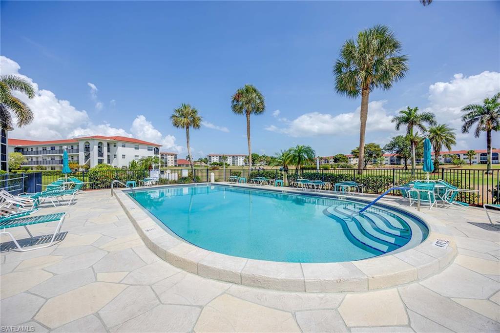 45 High Point Circle South, Unit 303 Naples, FL 34103 - Photo 22 of 22 a view of a swimming pool and a terrace