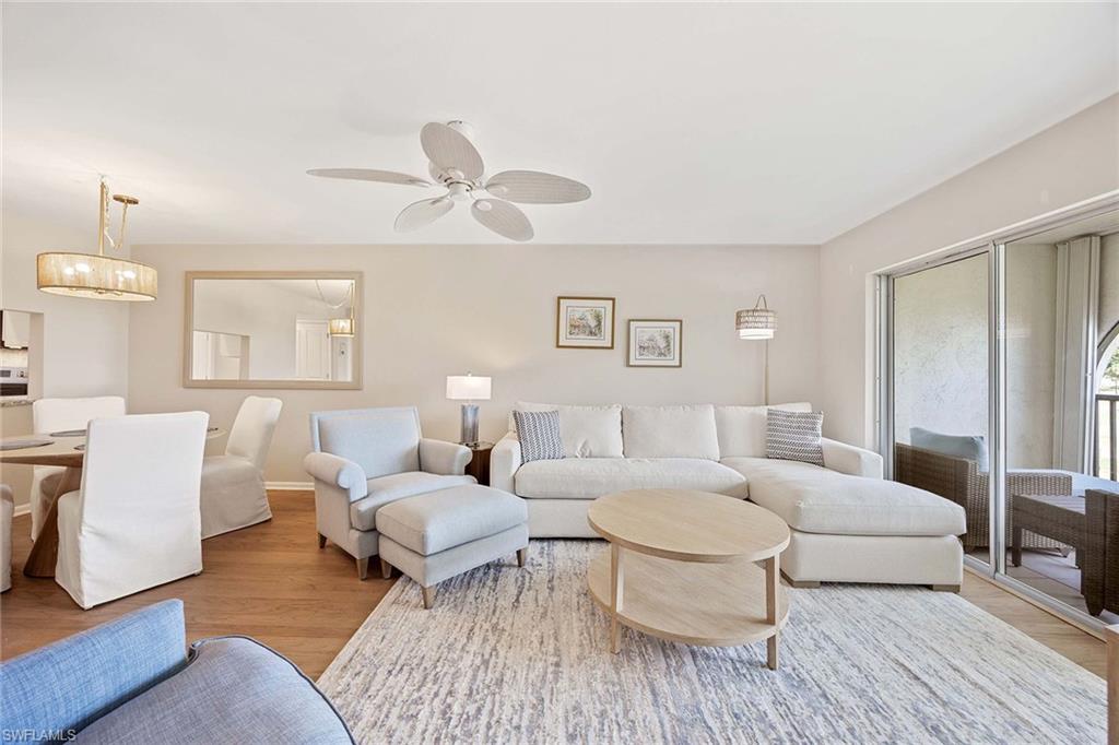 45 High Point Circle South, Unit 303 Naples, FL 34103 - Photo 5 of 22 a living room with furniture and a large window