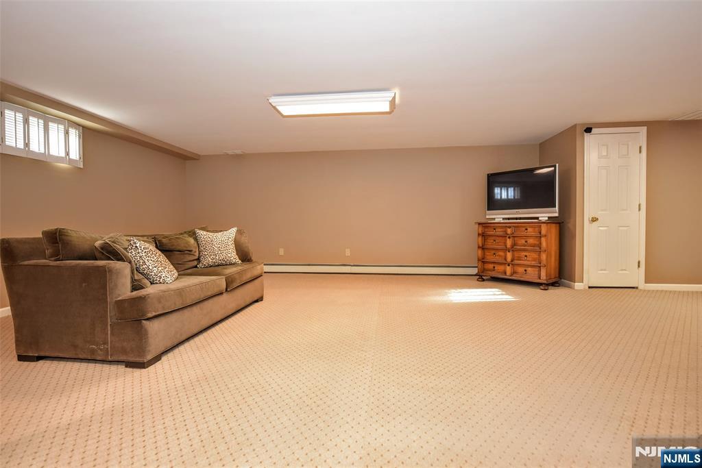 60 Dimmig Road Upper Saddle River, NJ 07458 - Photo 31 of 40 a living room with furniture and a flat screen tv