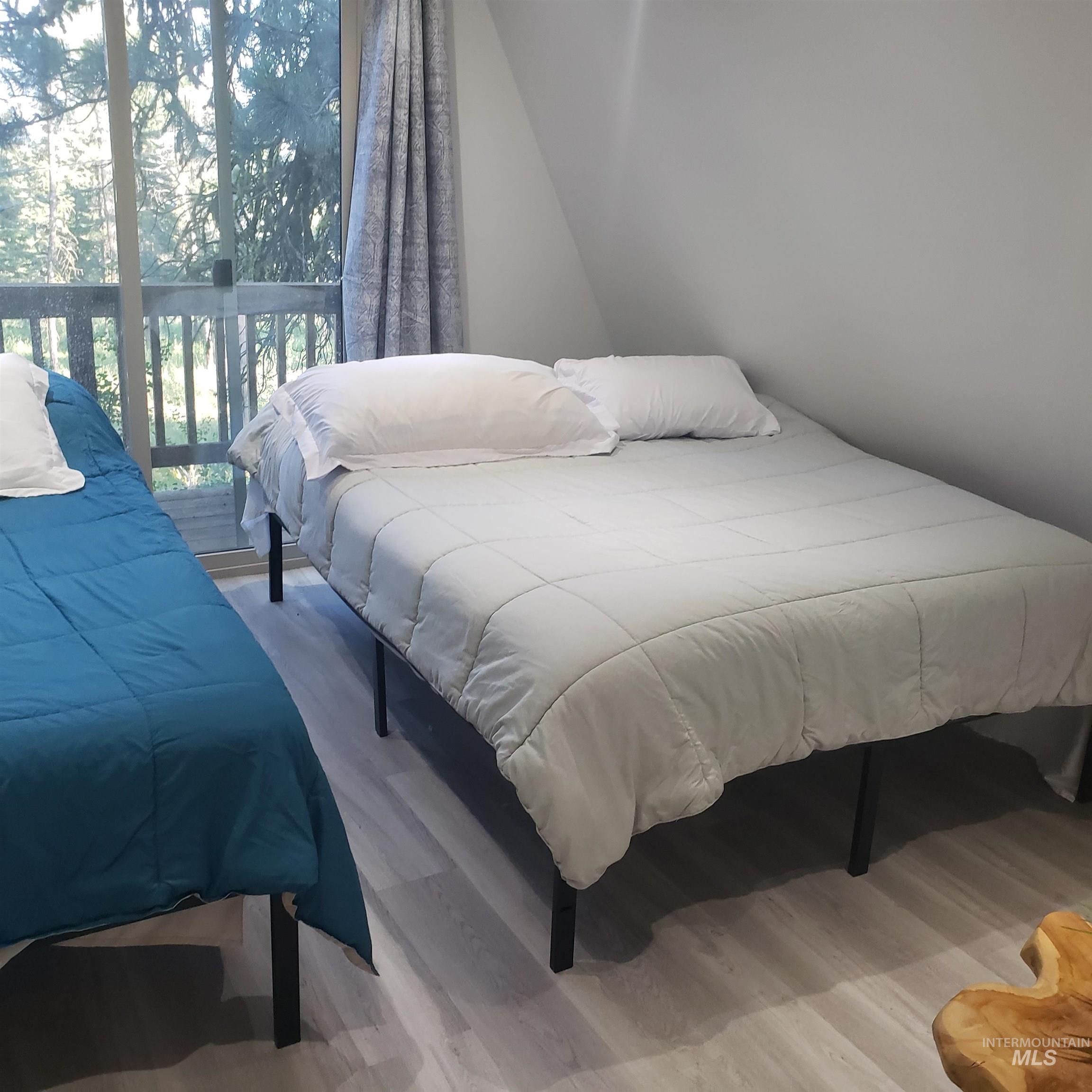 1098 Crescent Rim Drive McCall, ID 83638 - Photo 22 of 42 Bedroom with light wood-style floors and access to exterior