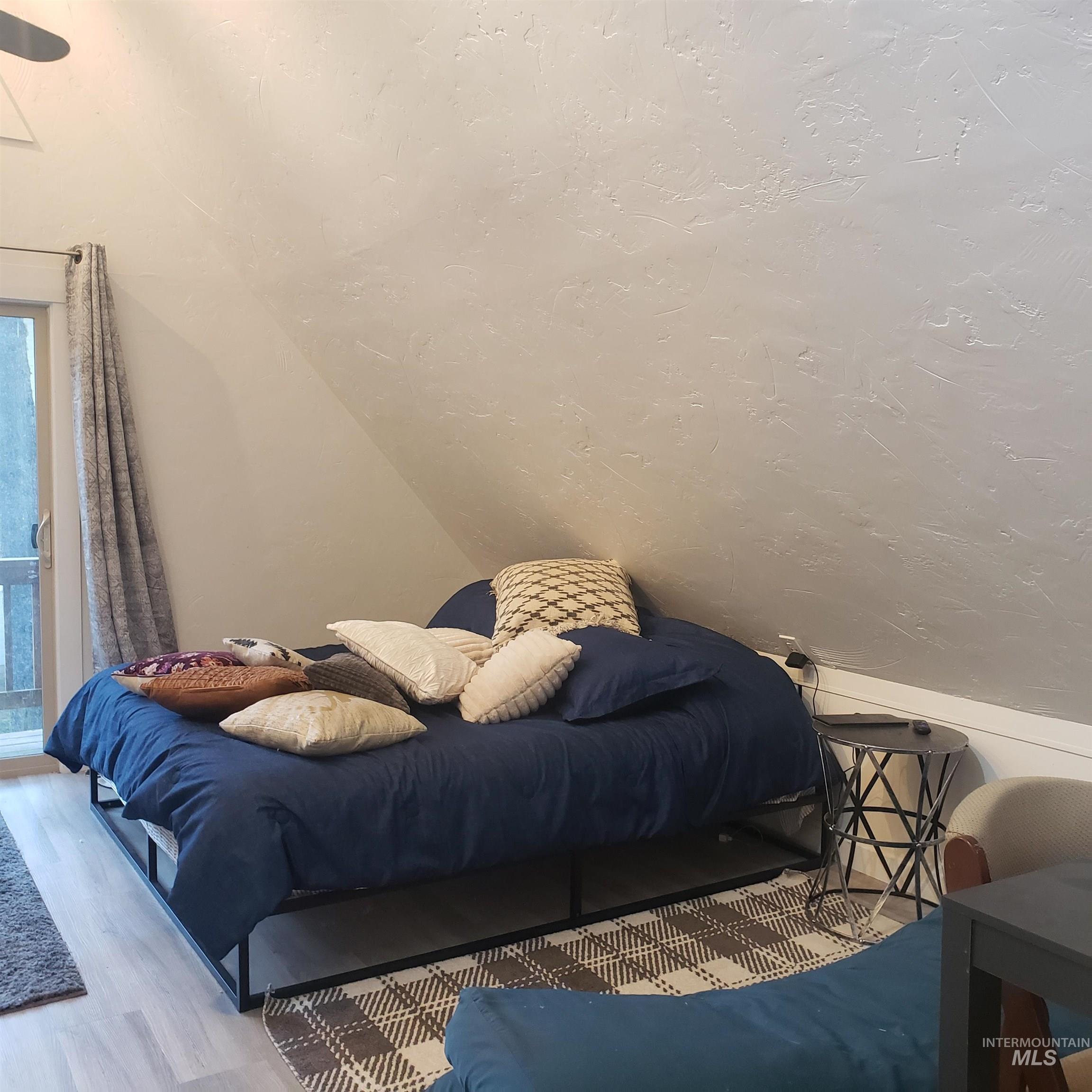 1098 Crescent Rim Drive McCall, ID 83638 - Photo 28 of 42 Bedroom featuring vaulted ceiling and wood finished floors