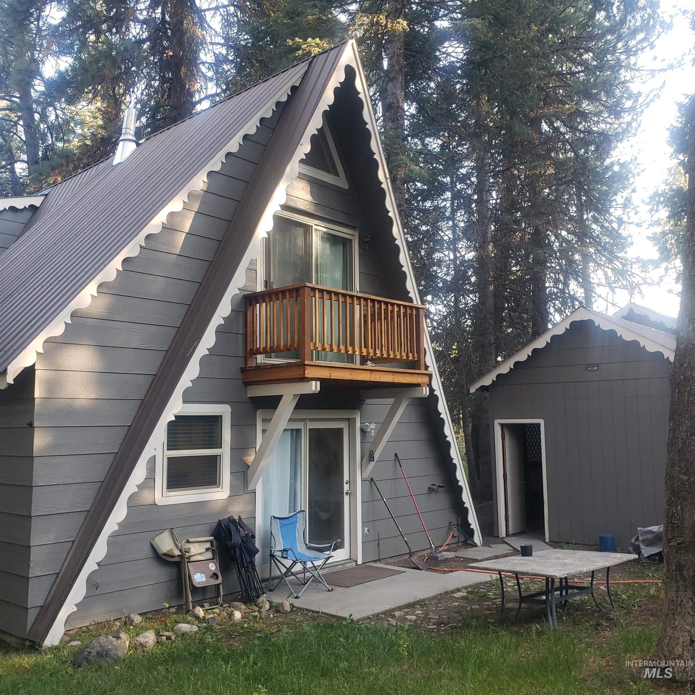 1098 Crescent Rim Drive McCall, ID 83638 - Photo 36 of 42 Back of property featuring a patio, an outbuilding, and a metal roof