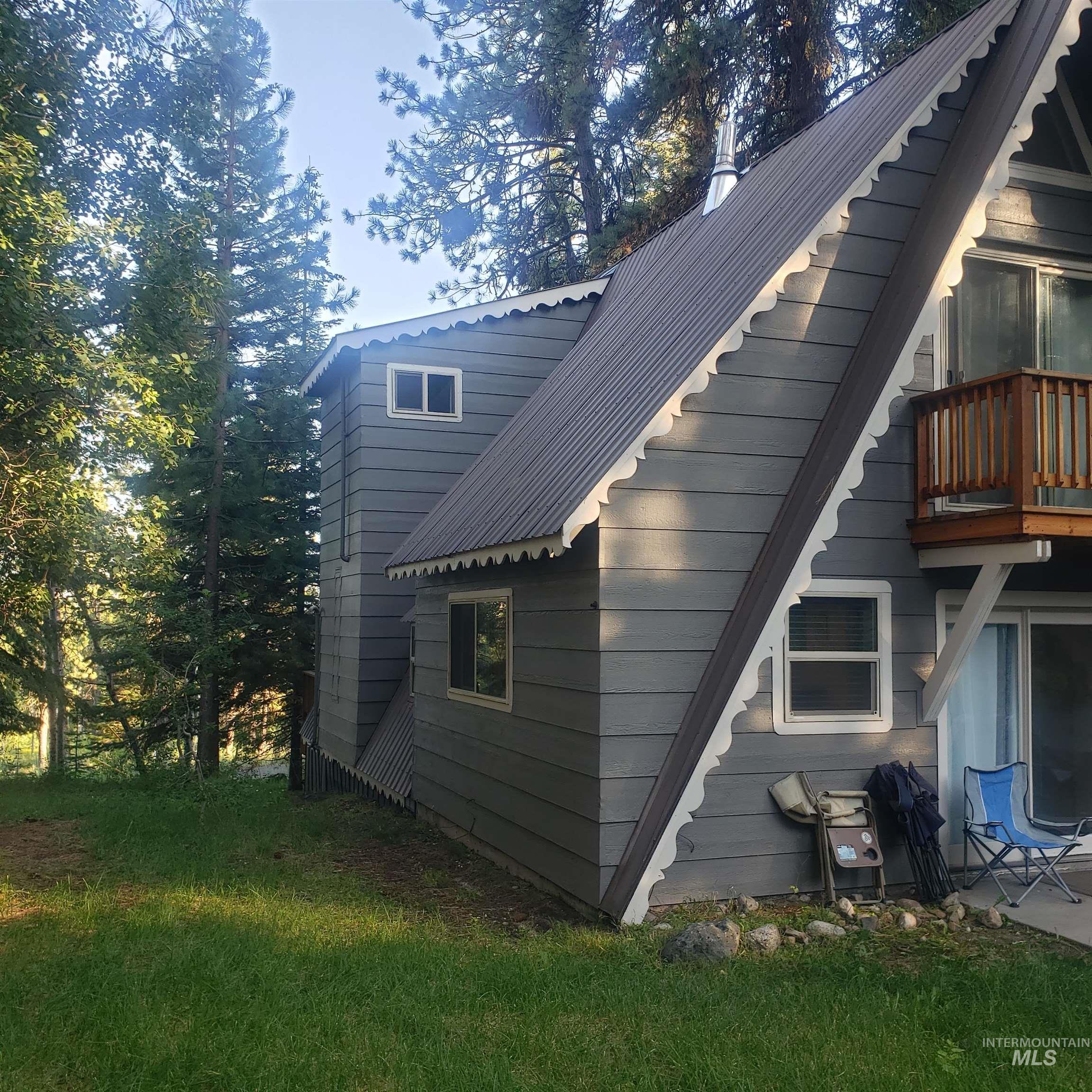 1098 Crescent Rim Drive McCall, ID 83638 - Photo 37 of 42 View of home's exterior with a metal roof and a balcony