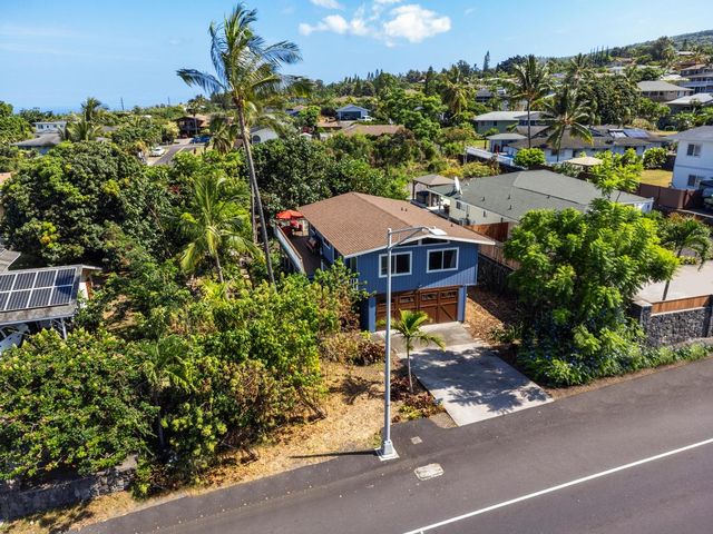 a view of a house with a yard and garden