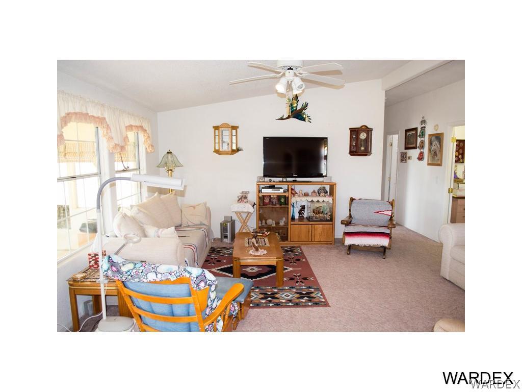 4117 Cove Road Golden Valley, AZ 86413 - Photo 12 of 32 a living room with furniture a flat screen tv and a window