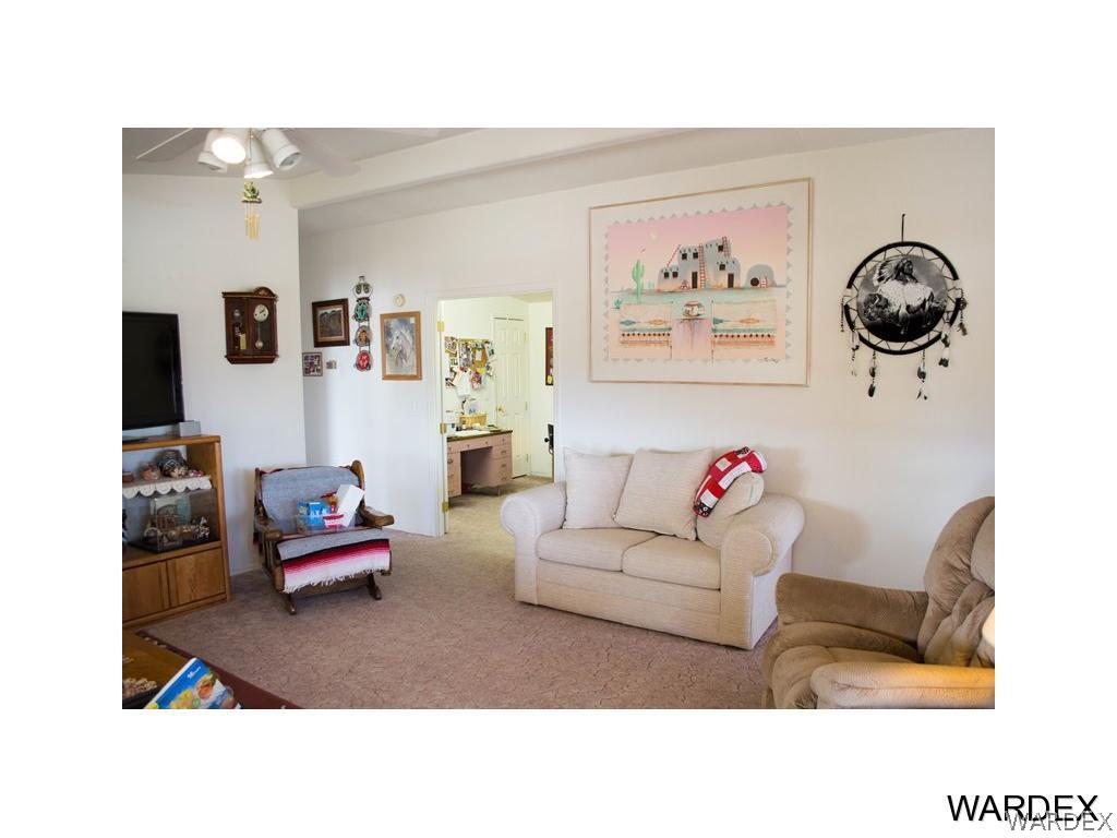 4117 Cove Road Golden Valley, AZ 86413 - Photo 13 of 32 a living room with furniture and a flat screen tv