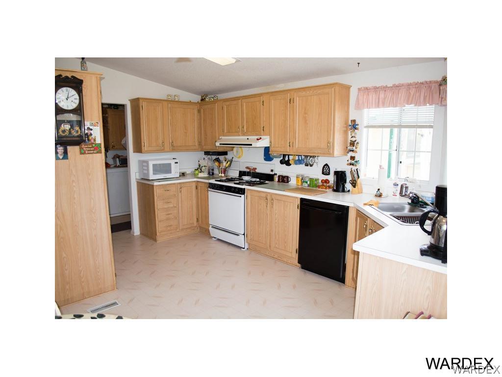 4117 Cove Road Golden Valley, AZ 86413 - Photo 14 of 32 a kitchen with stainless steel appliances granite countertop a sink stove and refrigerator