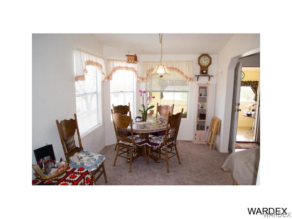 4117 Cove Road Golden Valley, AZ 86413 - Photo 15 of 32 a living room with furniture and a dining table