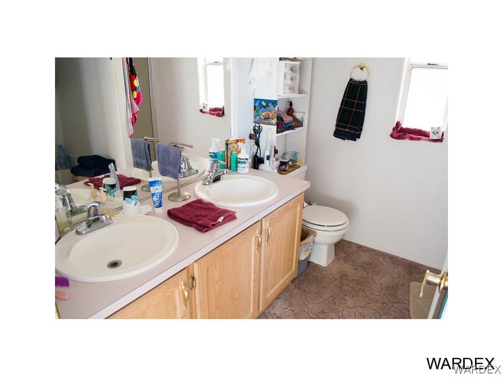 4117 Cove Road Golden Valley, AZ 86413 - Photo 18 of 32 a bathroom with a sink toilet and mirror