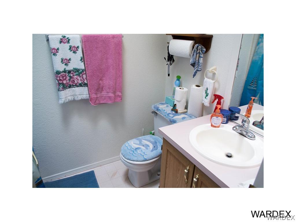 4117 Cove Road Golden Valley, AZ 86413 - Photo 21 of 32 a bathroom with a sink toilet and mirror
