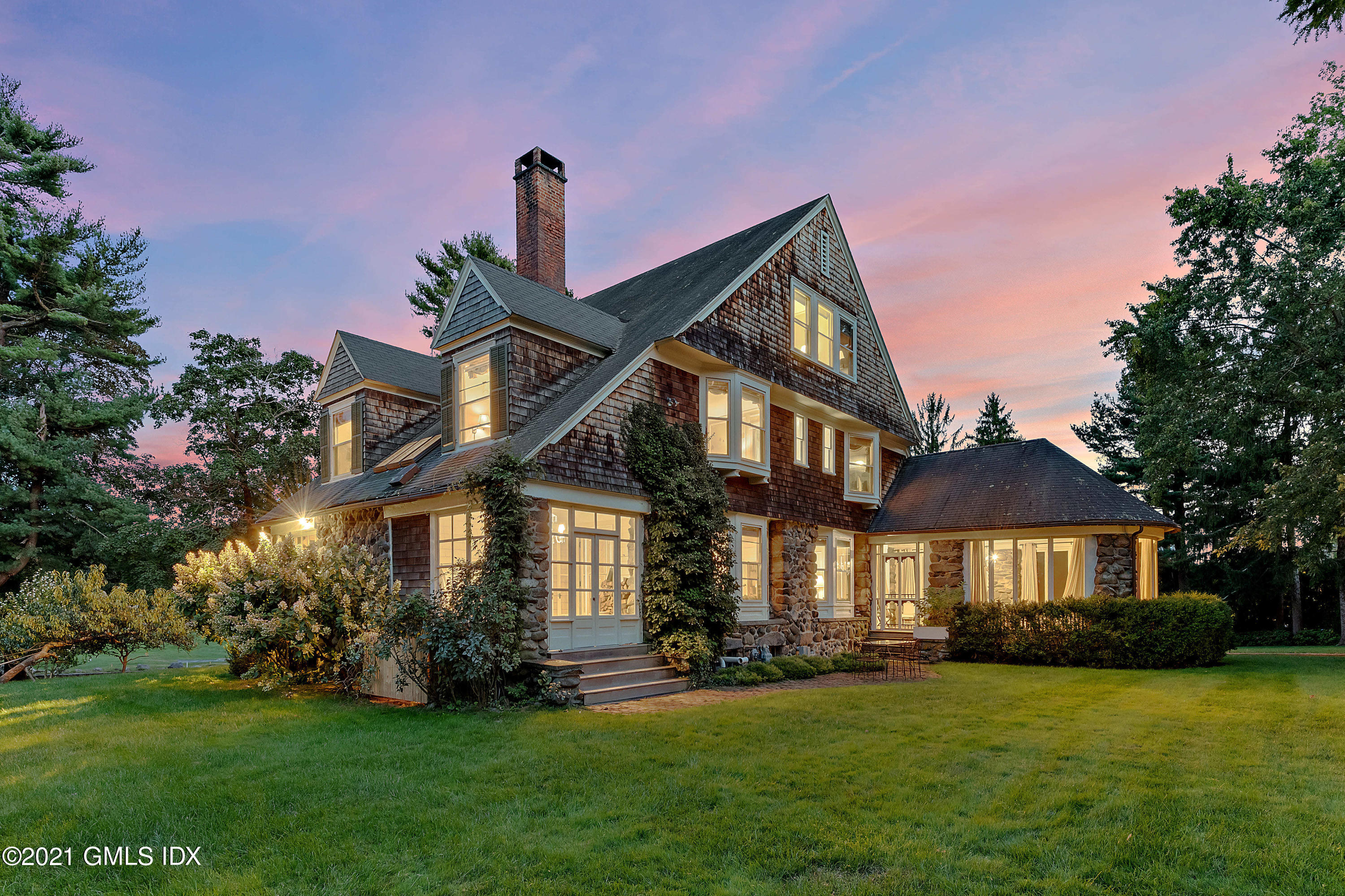 3 Fairfield Road Greenwich, CT 06830 - Photo 1 of 46 a front view of a house with a garden