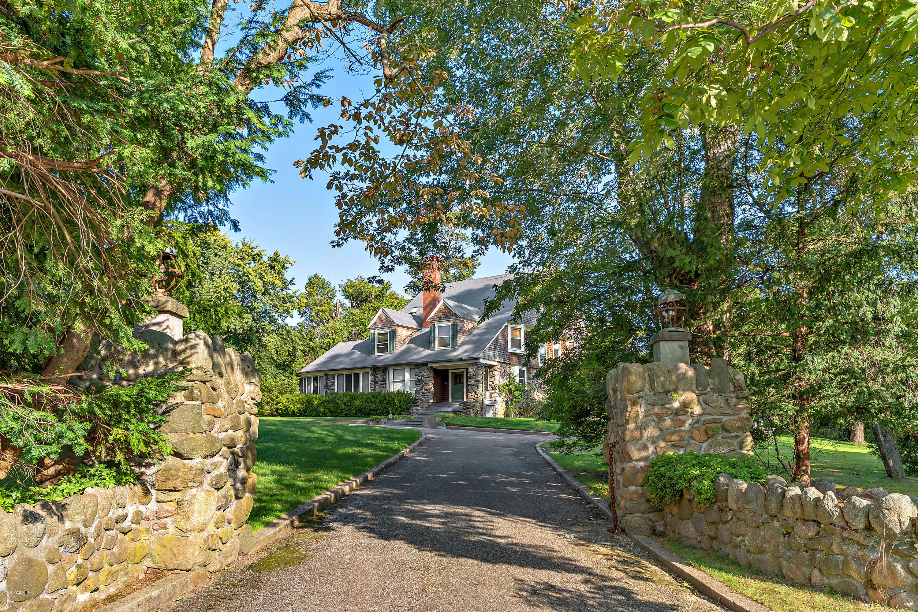 3 Fairfield Road Greenwich, CT 06830 - Photo 4 of 46 a front view of a house with a garden