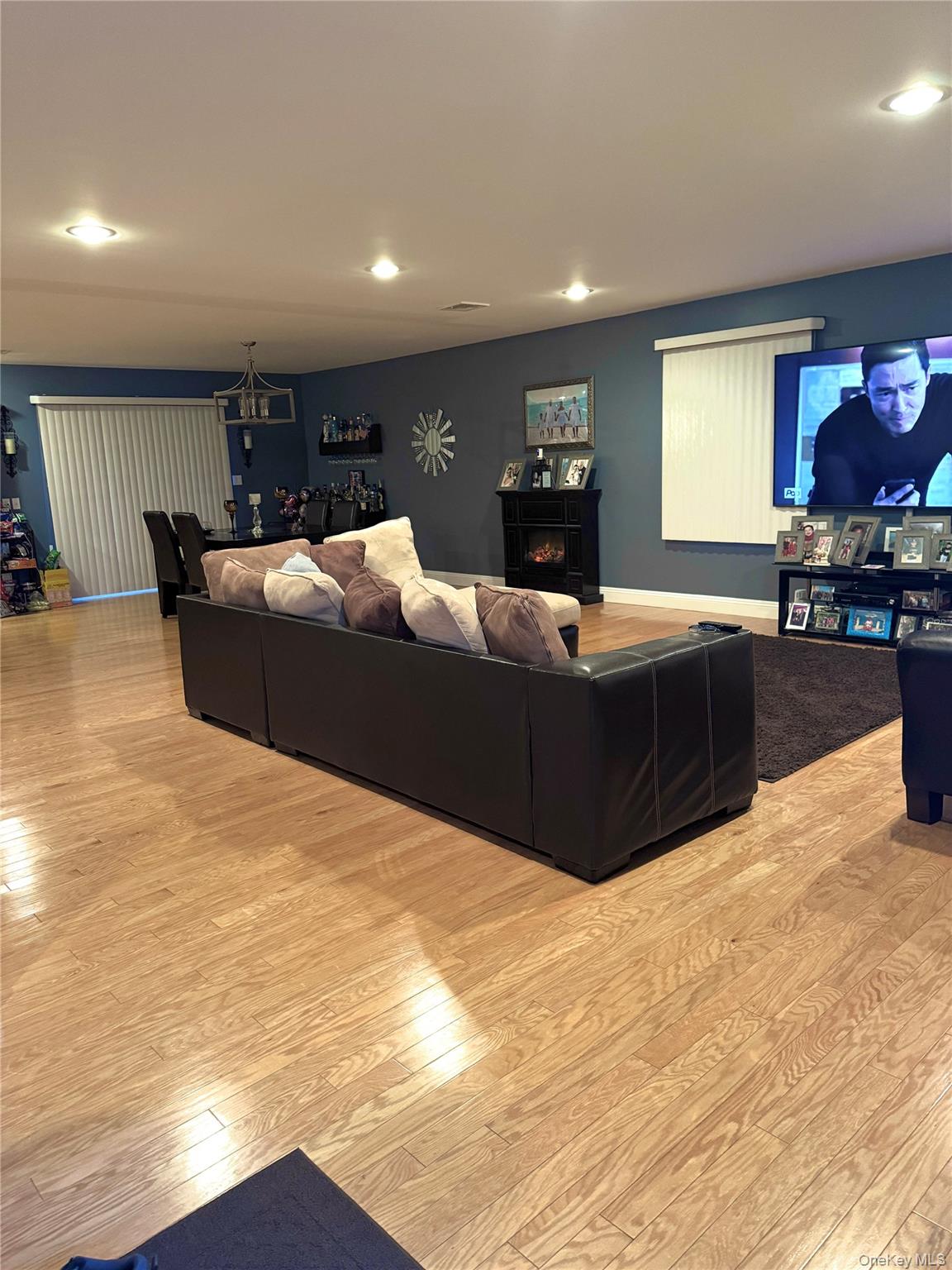 285 Daniel Street Lindenhurst, NY 11757 - Photo 12 of 15 a living room with furniture a fireplace and a flat screen tv