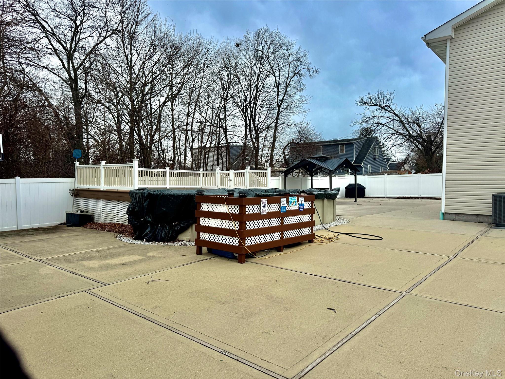 285 Daniel Street Lindenhurst, NY 11757 - Photo 4 of 15 a backyard of a house with barbeque oven and outdoor seating