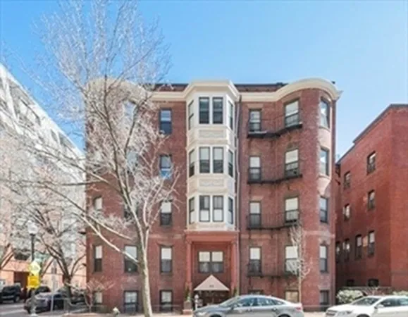 a front view of a building with a yard