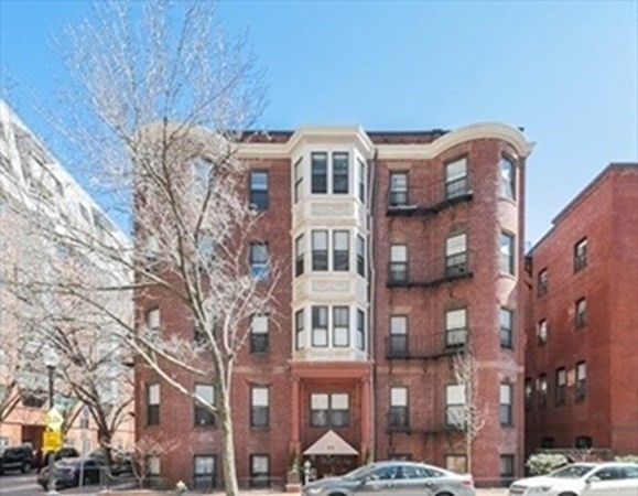 a front view of a building with a yard