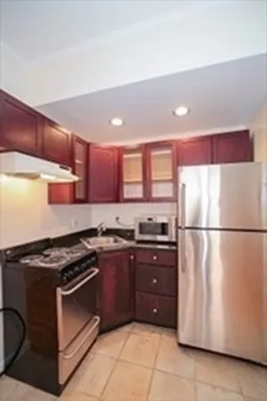 a kitchen with stainless steel appliances granite countertop a stove and a refrigerator