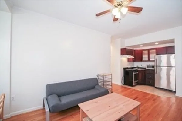 a living room with furniture and a kitchen