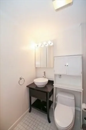a bathroom with a toilet a sink and a mirror