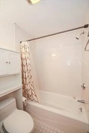 a bathroom with a toilet and shower