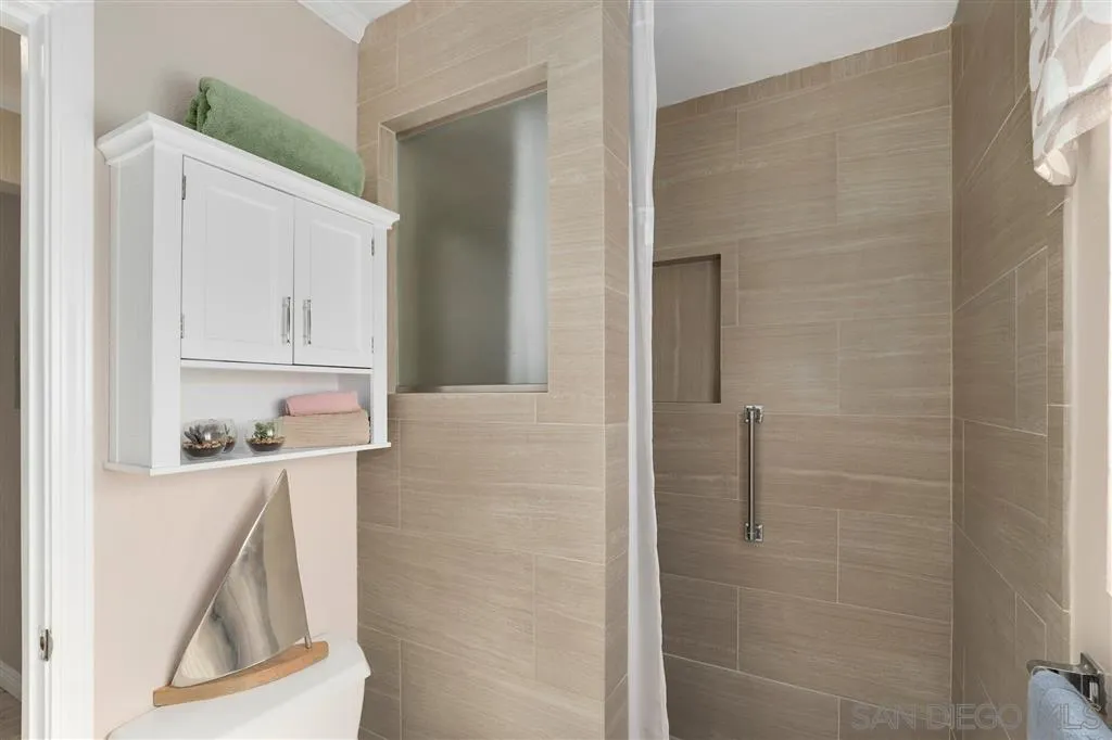 864 E Avenue Coronado, CA 92118 - Photo 13 of 20 a bathroom with a bathtub sink and mirror