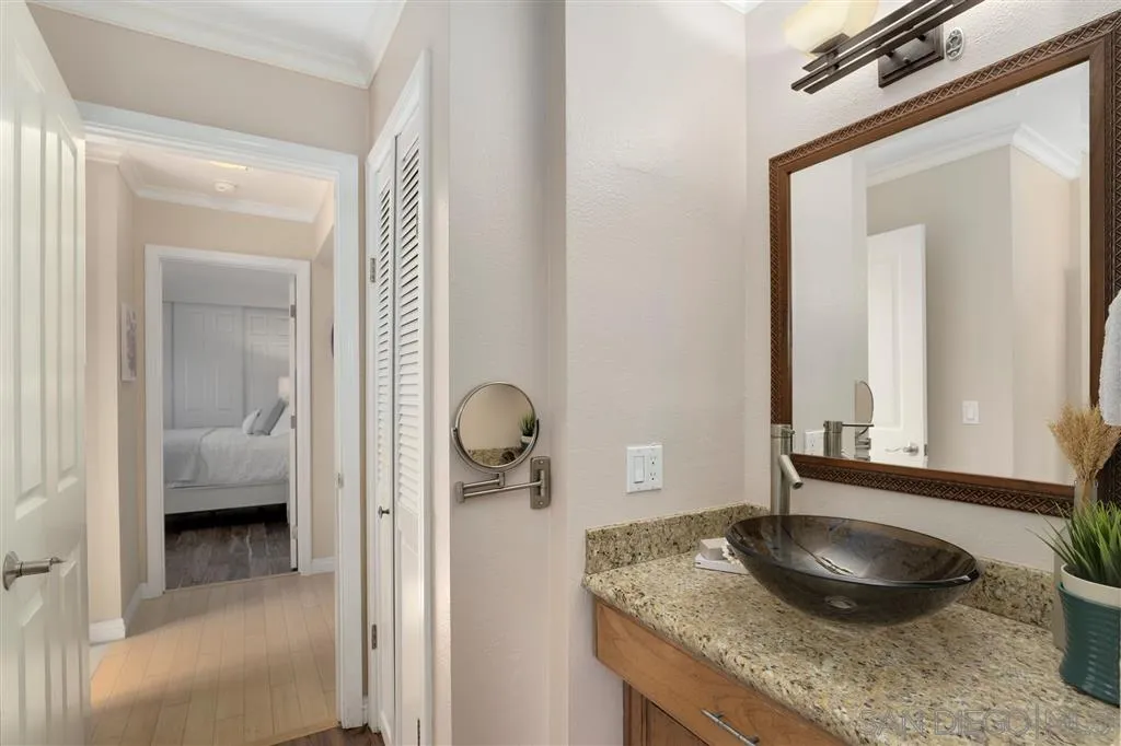 864 E Avenue Coronado, CA 92118 - Photo 15 of 20 a en suite bathroom with a granite countertop sink and a mirror