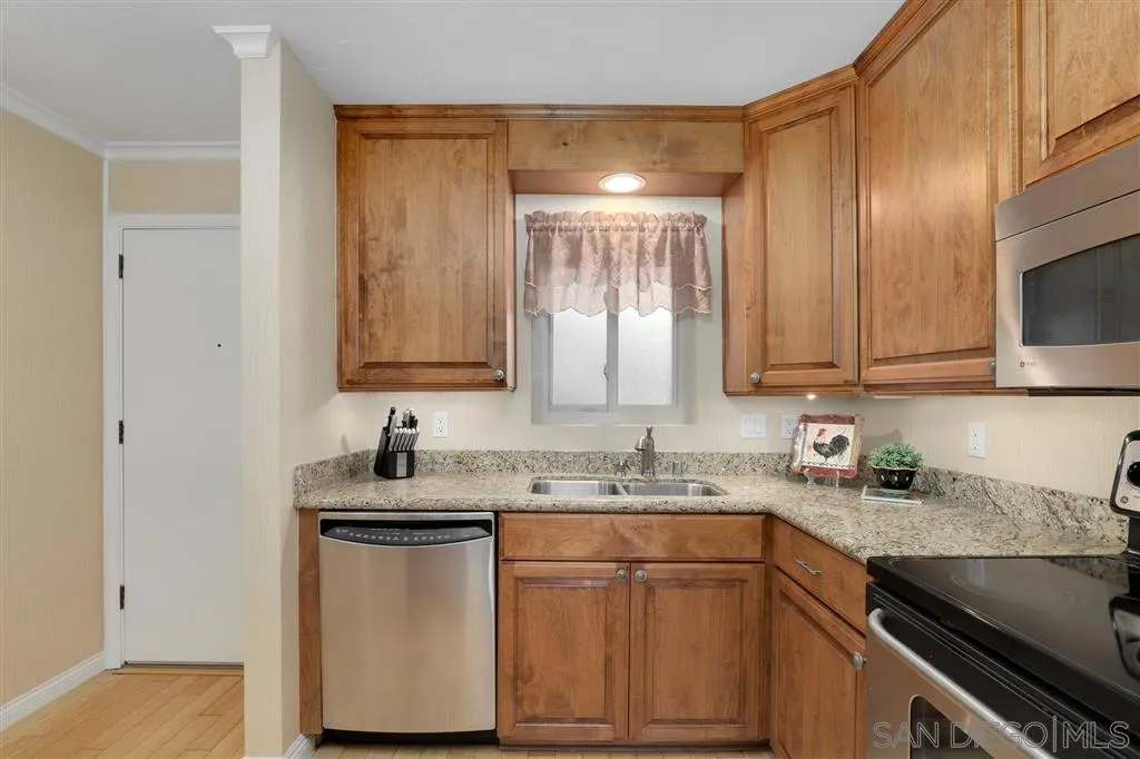 864 E Avenue Coronado, CA 92118 - Photo 8 of 20 a kitchen with stainless steel appliances granite countertop a sink stove and cabinets