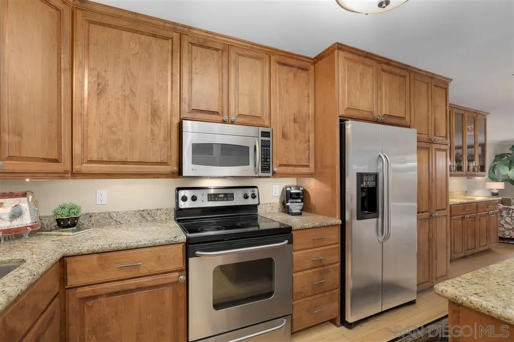 864 E Avenue Coronado, CA 92118 - Photo 9 of 20 a kitchen with stainless steel appliances granite countertop a refrigerator stove and sink