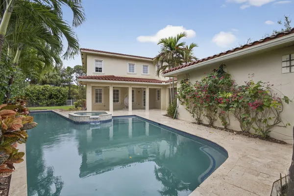 a view of a swimming pool with a yard