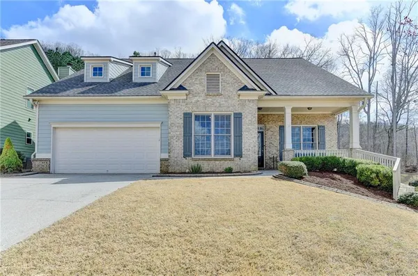 a front view of a house with a garden and entryway
