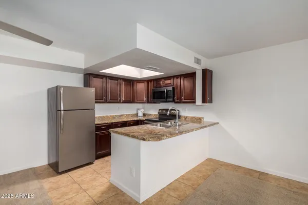 a kitchen with a sink stainless steel appliances and cabinets