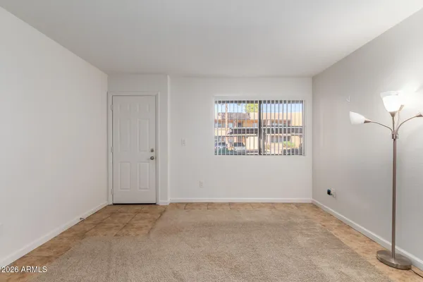 an empty room with fan and entrance