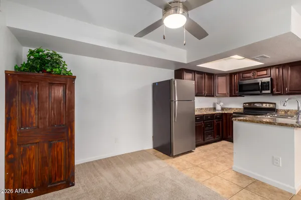 a kitchen with stainless steel appliances granite countertop a sink a refrigerator and a stove