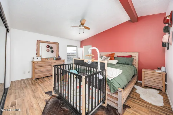 a bedroom with furniture and a wooden floor