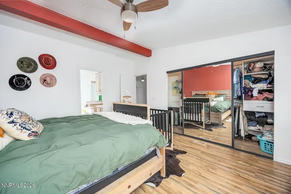 a bedroom with a bed and a large window