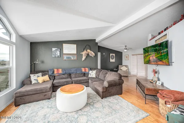 a living room with furniture and a flat screen tv