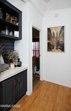 a kitchen with a wooden floor and cabinets