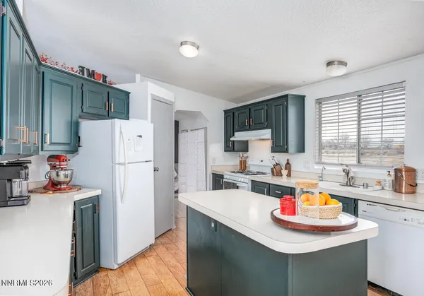 a kitchen with a sink a refrigerator and a stove