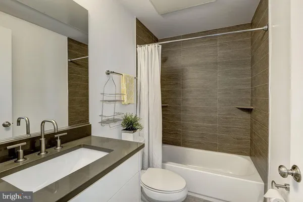 a view of an empty room with glass door and wooden floor