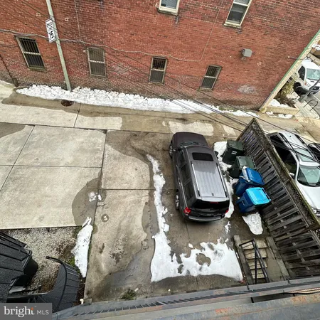 a living room with furniture a flat screen tv and kitchen view