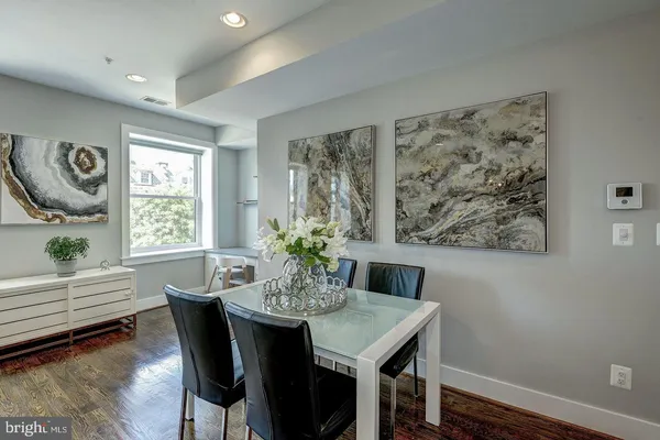 a view of a dining room with furniture and wooden floor