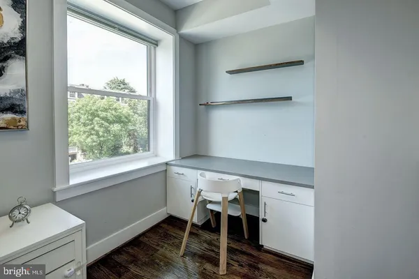 a bedroom with a bed and a lamp