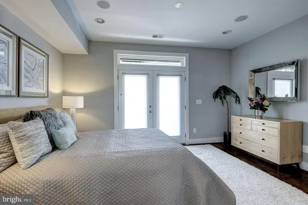 a bedroom with a bed and a dresser