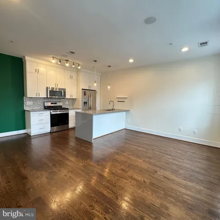 a view of a kitchen with a sink and a stove top oven