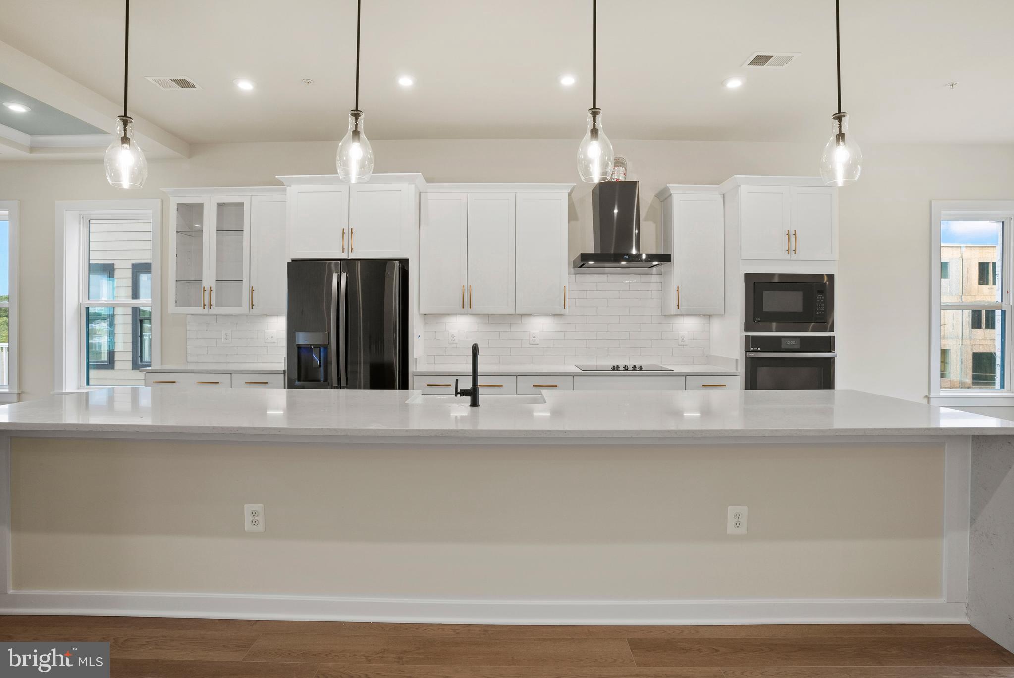 6713 Belcrest Road Hyattsville, MD 20782 - Photo 26 of 29 a large kitchen with stainless steel appliances kitchen island a large island a refrigerator and a sink