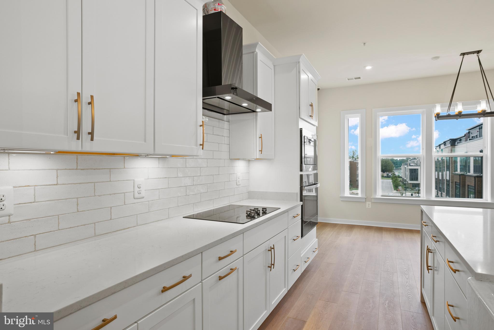 6713 Belcrest Road Hyattsville, MD 20782 - Photo 3 of 29 a kitchen with granite countertop a sink a stove and cabinets