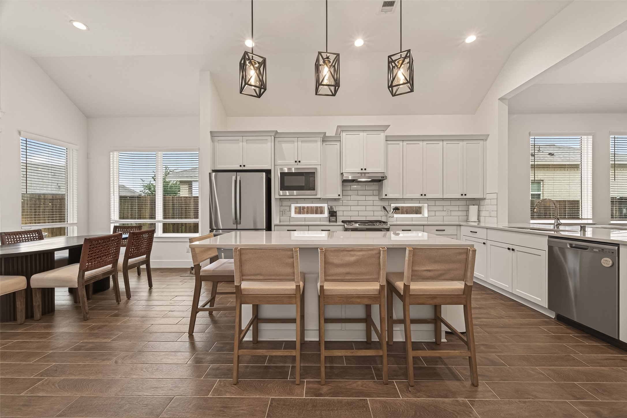 5019 Country Mdws Trail Rosharon, TX 77583 - Photo 15 of 49 a dining hall with stainless steel appliances kitchen island granite countertop a dining table chairs and view living room