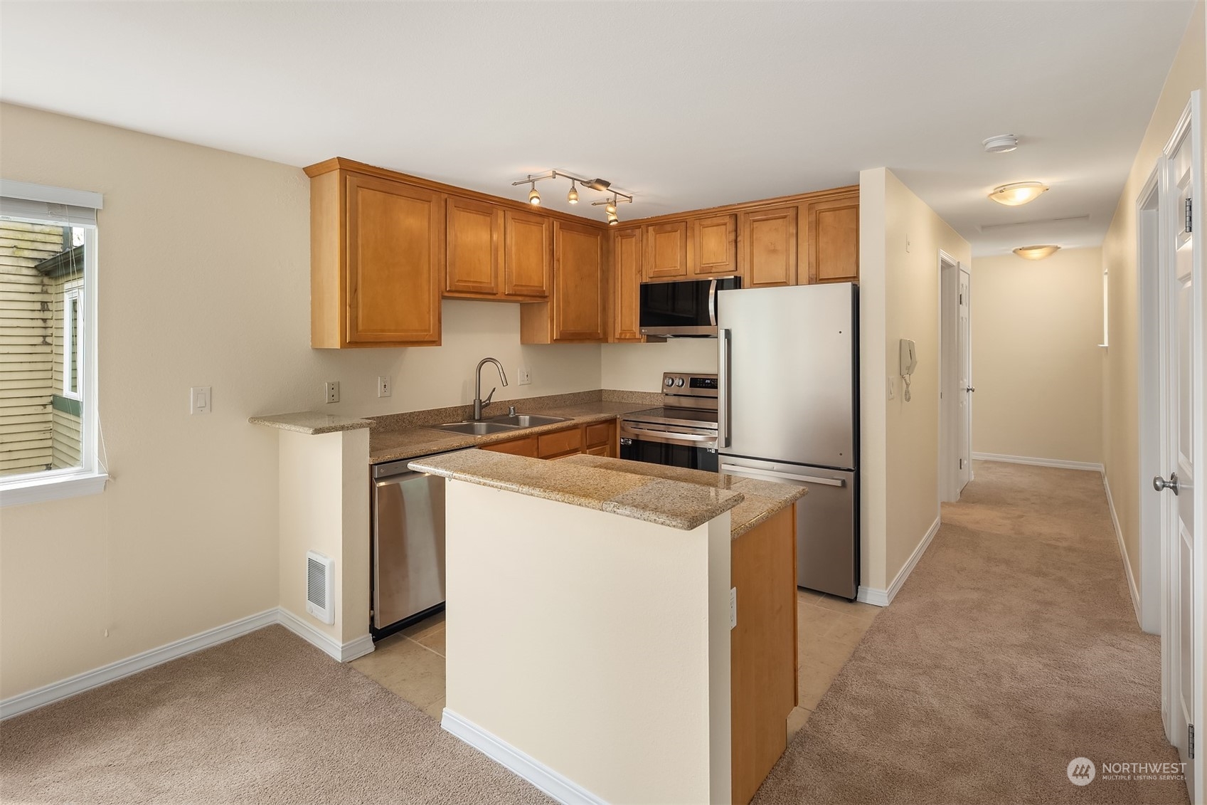 20320 Bothell Everett Highway, Unit D304 Bothell, WA 98012 - Photo 2 of 21 a kitchen with a refrigerator a sink and a cabinets
